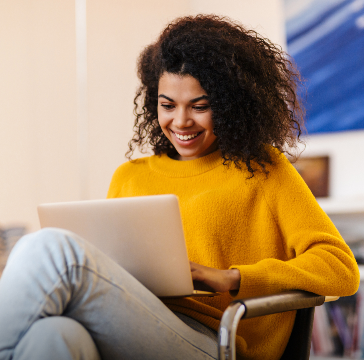 Woman in yellow dress using laptop