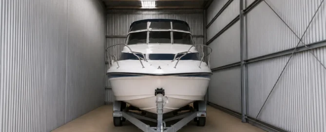 White motorboat stored indoors in a secure boat storage facility near Lake Eildon